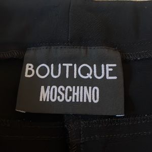 Vintage Boutique Moschino black pants with pockets and zippers at ankles.